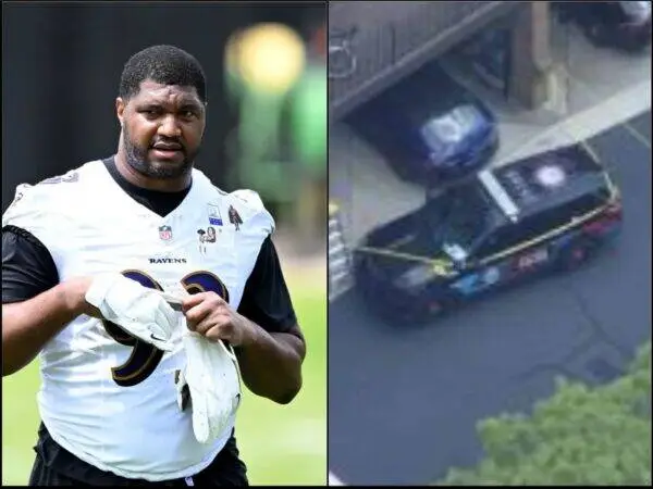 Male football player in a white Baltimore Ravens practice jersey, holding gloves. On the right, a vehicle is partially submerged in water near a building, viewed from above.