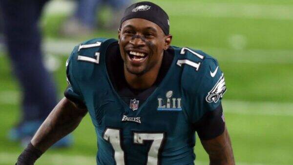 Philadelphia Eagles player in teal jersey #17, smiling on the field after a play.