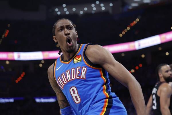 Thunder basketball player in a blue jersey (#8) yells during a game, arm raised in action on the court