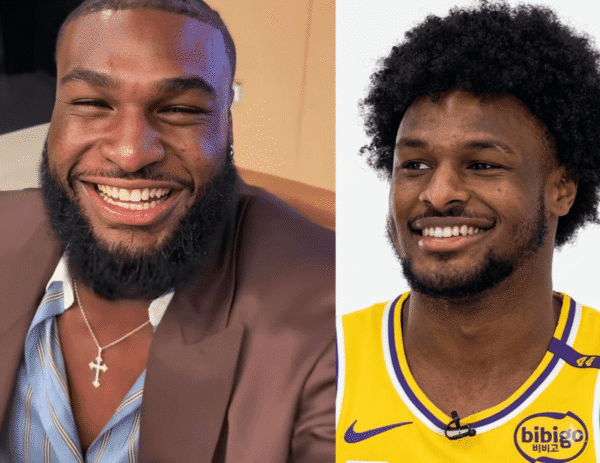 Two men smiling side by side: left in a brown suit and striped shirt with a cross necklace, right in a yellow basketball jersey, both looking happy.
