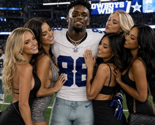 NFL player in white jersey #89 posing with six smiling fans on the field after a Cowboys win.