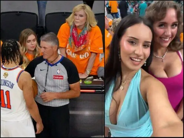 Basketball scene: a player in white jersey talks with a referee while team staff and fans watch nearby in a arena.