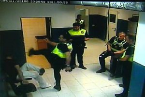 Cop karate kicks handcuffed suspect