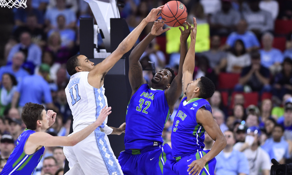 Mar 17, 2016; Raleigh, NC, USA; North Carolina Tar Heels forward Brice Johnson (11) battles for the ball with Florida Gulf Coast Eagles forward Antravious Simmons (32) and guard Julian DeBose (3) in front of Eagles guard Christian Terrell (11) during the first half at PNC Arena. Mandatory Credit: Bob Donnan-USA TODAY Sports