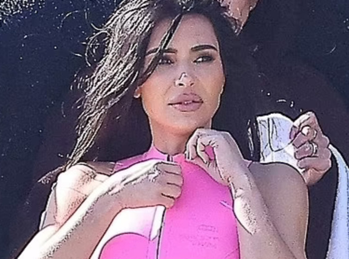 Kim Kardashian slips her famous curves into a racy pink thong