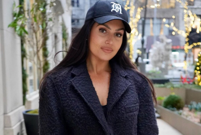 ESPN’s “First Take” Host Molly Qerim Poses And Shows Off In Winter Coat While On Christmas Vacation