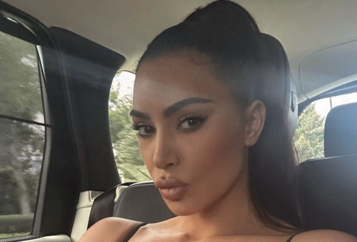 Kim Kardashian Poses And Pouts While Showing Off Massive Cleavage In A Tight Black Tank