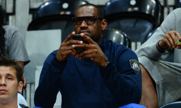 ORG XMIT: USPW-GRP-122 Aug 1, 2012; London, United Kingdom; USA men's basketball player LeBron James holds his cell phone in the first half of a preliminary round group A game between USA and Turkey during the London 2012 Olympic Games at Basketball Arena. Mandatory Credit: Kyle Terada-USA TODAY Sports ORIG FILE ID: 20120801_ter_st3_102.jpg