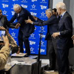 Watch Jerry Jones Stumble While Getting Up To Greet Bill Clinton