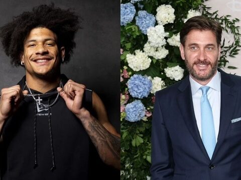 Side-by-side: left, a smiling man with curly hair wearing a black sleeveless hoodie and chains; right, a man in a navy suit with a light blue tie at a floral backdrop.