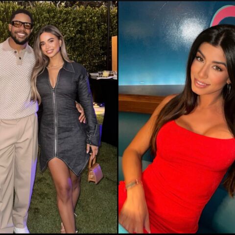 Man and woman posing together outdoors at a evening event; man in a light patterned polo and beige pants, woman in a dark zip-front dress with long blonde hair.