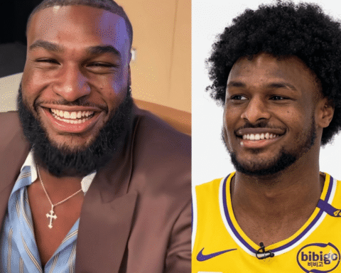 Two men smiling side by side: left in a brown suit and striped shirt with a cross necklace, right in a yellow basketball jersey, both looking happy.