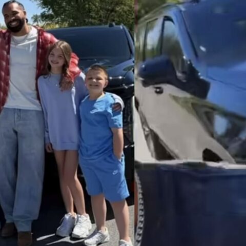 Family of four posing together outdoors in front of a black SUV on a sunny day.