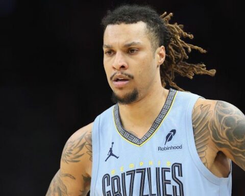 Basketball player in a light blue Memphis Grizzlies jersey with dreadlocks, focused on the court.
