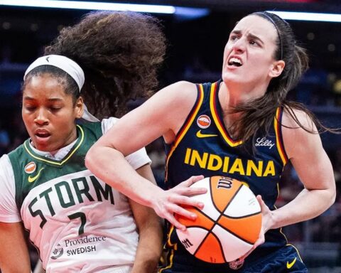 Two female basketball players compete for the ball: an Indiana player in blue drives forward while a Storm defender reaches in.