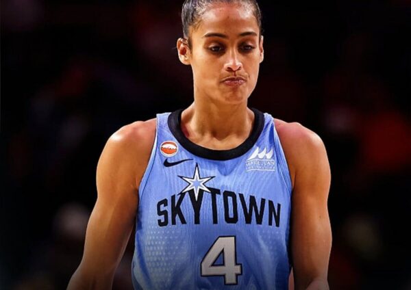 Female basketball player wearing a light blue SkyTown jersey with number 4, looking focused on the court.