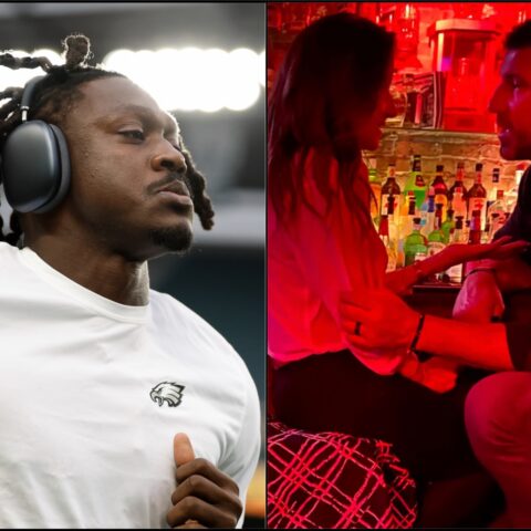 Close-up of a man wearing large over-ear headphones, looking to the side at a music event or DJ setup.