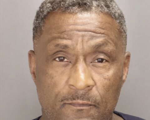 Mugshot of a middle-aged Black man with short gray hair, looking straight at the camera, neutral expression.