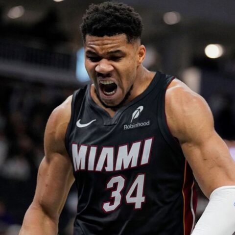 Miami Heat player in jersey #34 shouting intensely on the court during a game, muscles tensed and mouth open in a roar.