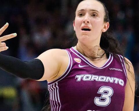 Female basketball player in Toronto jersey #3 extending arm in a dynamic pose during a game.