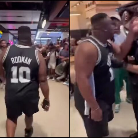 Back view of a man in a basketball jersey with 'Rodman 10' walking through a crowded area