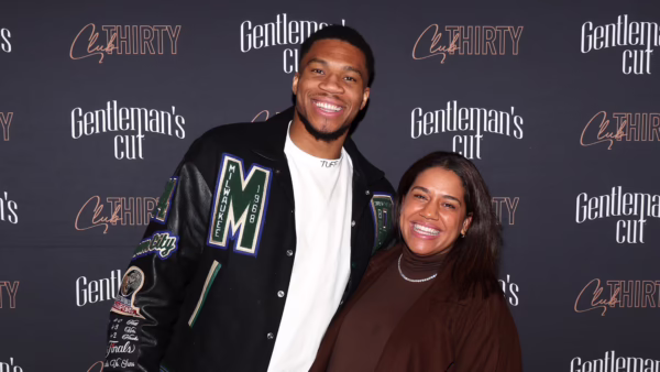 Two people posing and smiling at a photo backdrop reading 'Gentleman's Cut' and 'Cut THIRTY' festivals behind them.