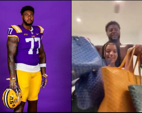 LSU football player in purple-and-gold uniform (#77) holding his helmet against a purple backdrop.