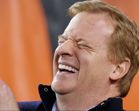 Man laughing with eyes closed, mouth open in a joyful smile (close-up portrait).