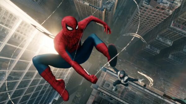 Spider-Man swings between skyscrapers above a city, feet extended, chasing a figure on a high ledge below him.