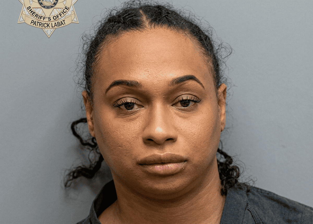 Mugshot of a woman with a neutral expression, gray background, sheriff's office badge in the top-left corner labeled Patrick Labat.