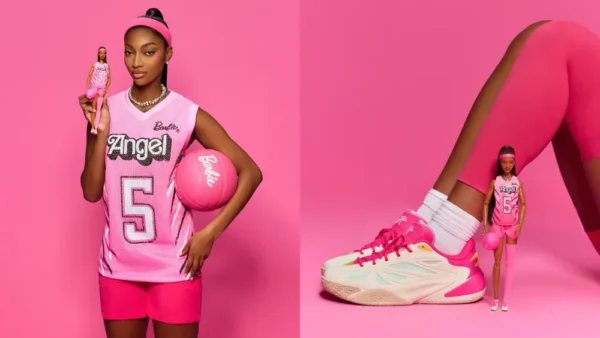 Girl in a pink basketball jersey and shorts holds a Barbie doll and a pink ball against a pink background.